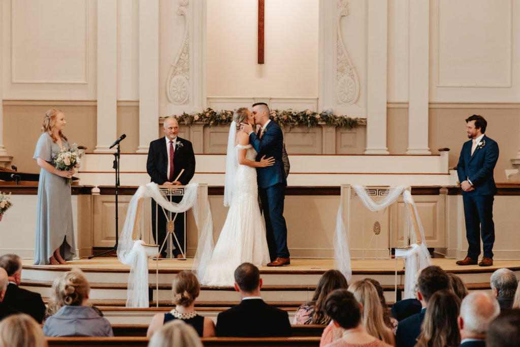 north Georgia wedding bride and groom in church at ceremony first kiss