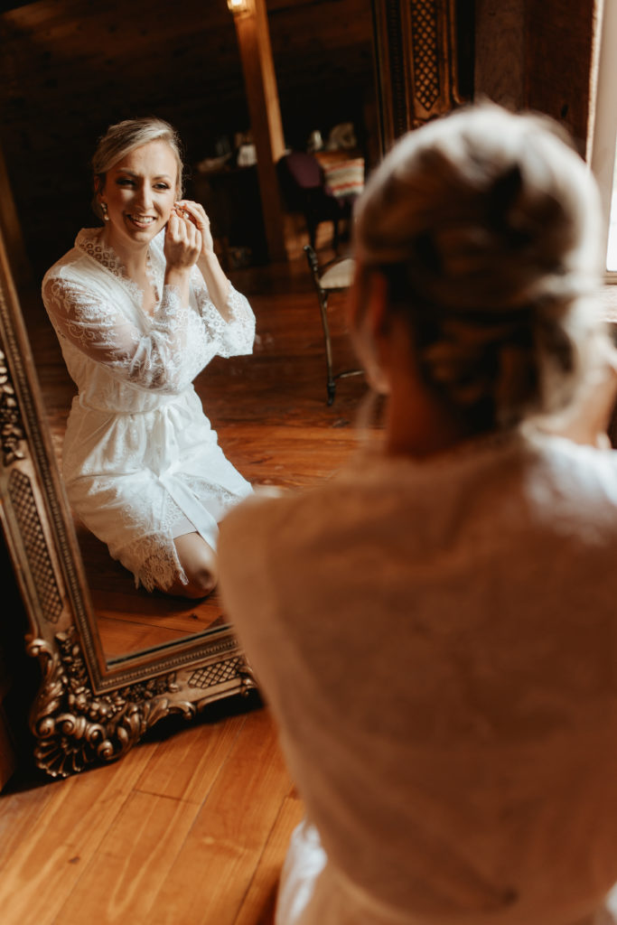 bride putting on earrings for North georgia wedding
