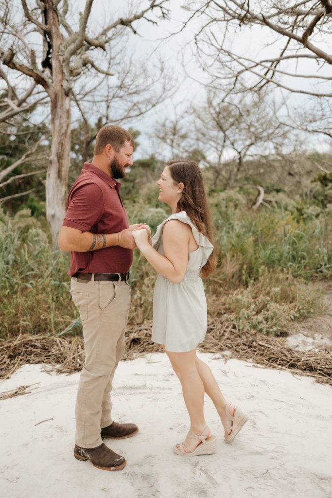 Newly engaged couple at Jekyll Island Driftwood Beach engagement session