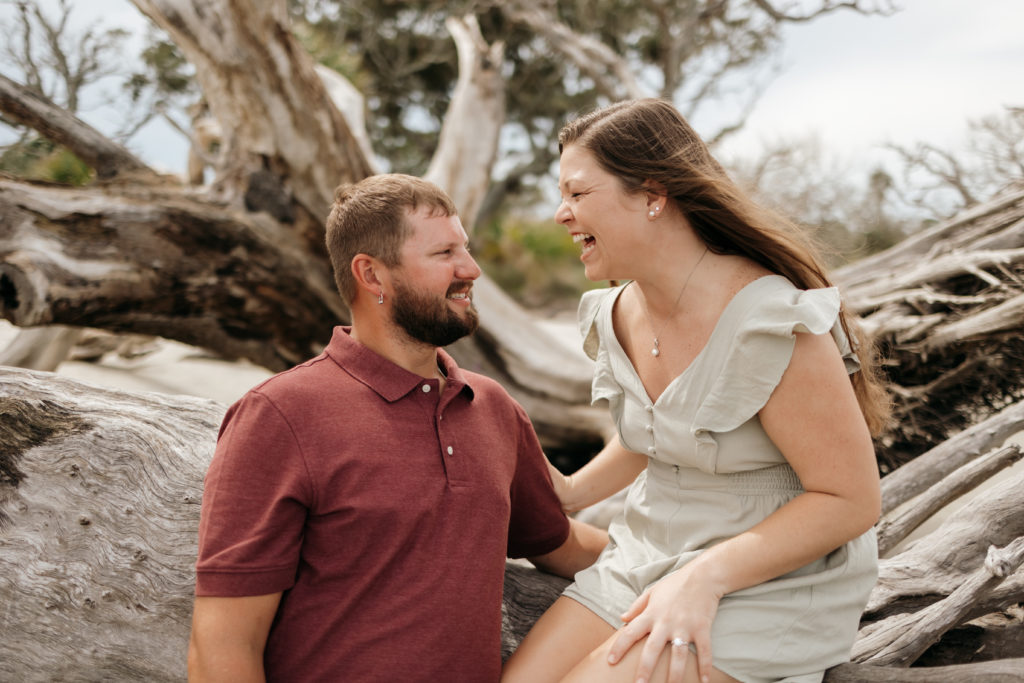 Couple laughing during Jekyll Island Driftwood Beach engagement session