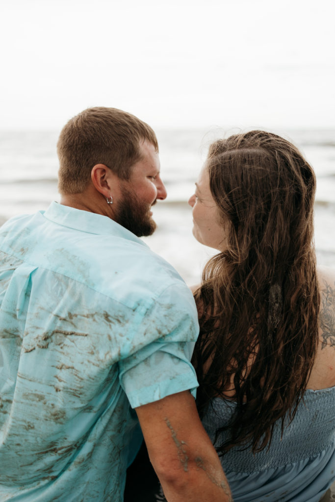 Couple posing on Driftwood Beach for engagement session 
