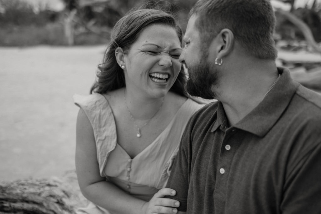 Couple laughing during Jekyll Island Driftwood Beach engagement session